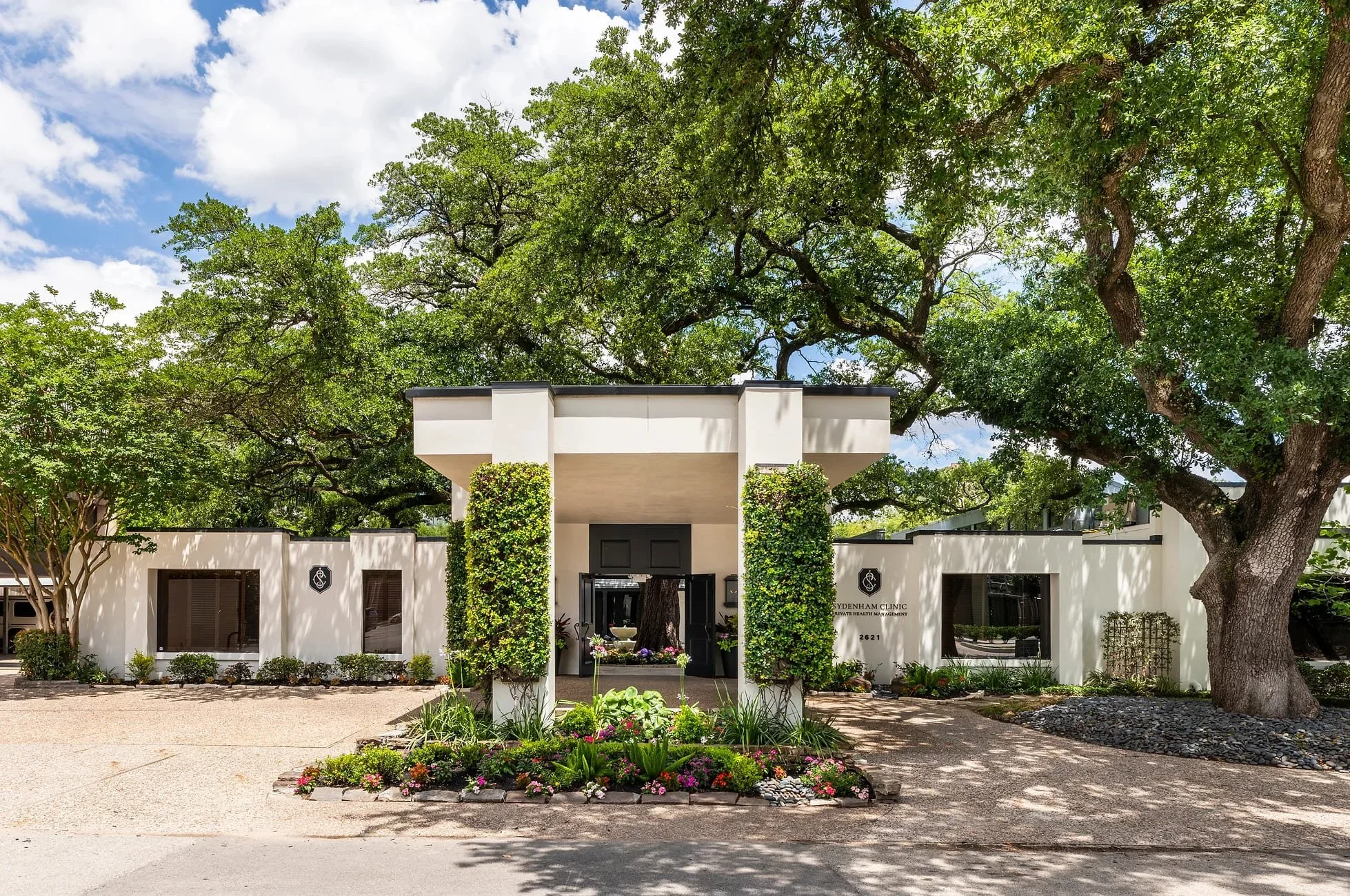 Commercial interior design Houston – Sydenham Clinic exterior with modern architectural façade and landscaped entry